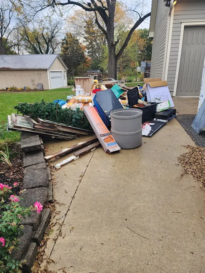Dumpster being loaded with debris for Estate Cleanout Dumpster Rental in Derby